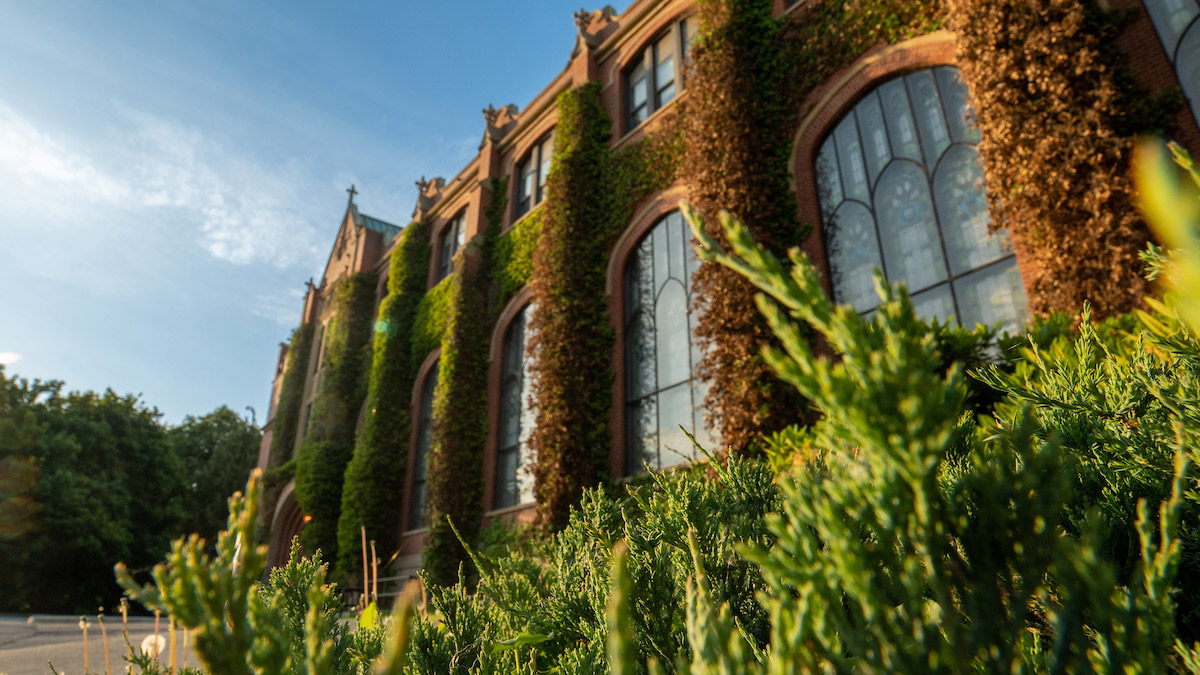 The Administration Building in spring, with plants growing.