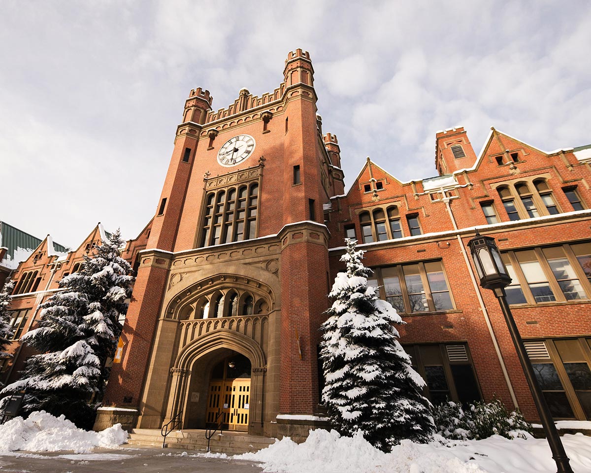 The Administration Building in winter, with snow on the roof and trees