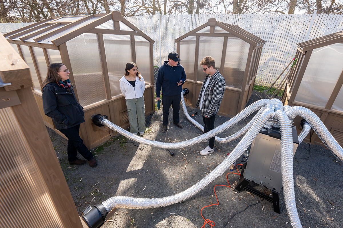 Students stand next to prototype smoke generators.