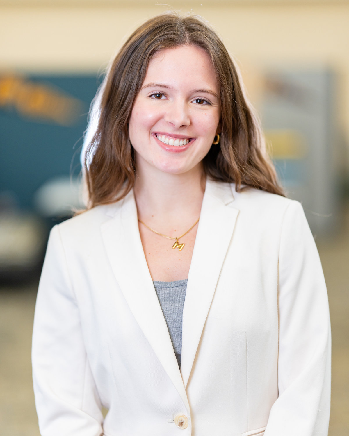 Woman wearing white sport jacket smiles